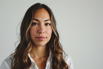 Wall Mural - Close up portrait of a beautiful young woman with long hair looking at camera