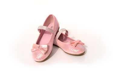 little girl's pink sparkly make belief princess shoes, bows and glitter for little princess on light background, happy childhood, Stylish pink outfit for party