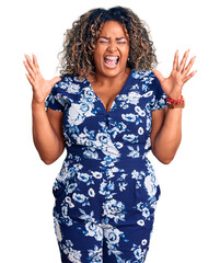 Wall Mural - Young african american plus size woman wearing casual clothes celebrating mad and crazy for success with arms raised and closed eyes screaming excited. winner concept