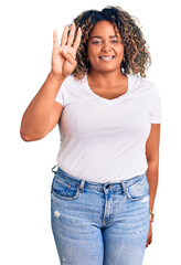 Wall Mural - Young african american plus size woman wearing casual clothes showing and pointing up with fingers number four while smiling confident and happy.