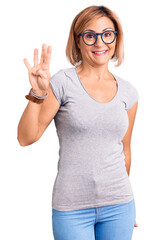 Wall Mural - Young blonde woman wearing casual clothes showing and pointing up with fingers number four while smiling confident and happy.