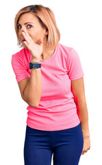 Poster - Young blonde woman wearing sportswear hand on mouth telling secret rumor, whispering malicious talk conversation