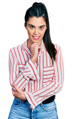 Canvas Print - Young hispanic woman wearing casual clothes smiling looking confident at the camera with crossed arms and hand on chin. thinking positive.