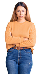 Sticker - Beautiful young woman wearing casual clothes skeptic and nervous, disapproving expression on face with crossed arms. negative person.