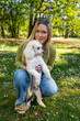 Portrait of beautiful girl in the park posing with her pet poodle 