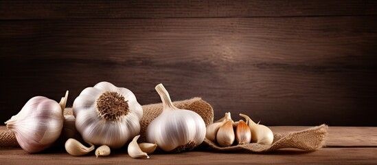 Poster - Cluster of fresh garlic cloves arranged on a rustic wooden table