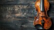 Antique violin rests against rustic, weathered wooden background, evoking classical and vintage atmosphere
