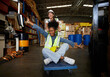 © offsuperphoto - factory workers moving cart and having fun in the warehouse storage