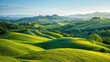 A peaceful countryside scene, with rolling hills blanketed in lush greenery under a clear blue sky.