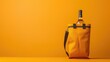 Wine bottle in yellow insulated carrier bag against vibrant background