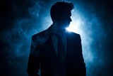 Fototapeta Sport - A mysterious silhouette of a person in a suit stands tall in a dimly lit room, exuding an aura of intrigue and sophistication.