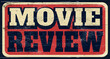 Aged and worn movie review sign on wood