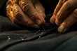 Close-up shot of a tailors hands sewing on a piece of cloth