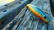 A close-up of a colorful fishing lure resting on a wooden dock, ready to attract a big catch.