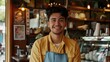 © yj - Happy young male cafe owner standing with smiling at the camera in front of his shop interior, in the style of a portrait shot. generative AI
