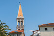 Traditional style European church tower against blue sky
