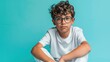 A young boy with glasses sitting on the floor. Suitable for educational or lifestyle concepts