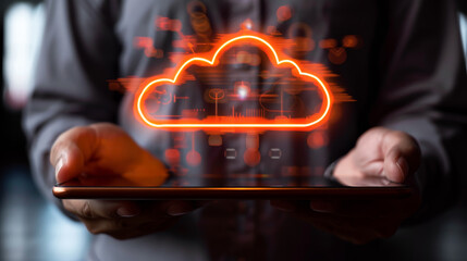 Person holding a tablet with a glowing cloud symbol above it, representing cloud data storage technology on a dark background. Generative AI