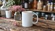  A white coffee mug rests atop a wooden table, adjacent to a vase with vibrant pink blossoms