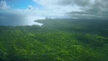 Aerial View Of Bright Green Valley And Ocean Bay On A Cloudy Day. Flying Over The Valleys Of Molokai Island, Hawaii.