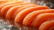   A tight shot of carrots in a heap on a table, topped with a pinch of salt