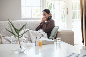 Wall Mural - Sick woman, tissue and blowing nose with flu, cold or illness on living room sofa at home. Young female person with medication for sneeze, fever or influenza from infection on lounge couch at house