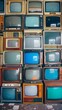 Close up Straight frontal photo of a big wall with different large and smaller retro vintage television screens