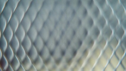 A hyper macro shot of a metal grid, steel pattern, iron industrial texture, aluminum material, super slow motion, Full HD 120 fps, smooth crane movement, blurry Depth Of Field