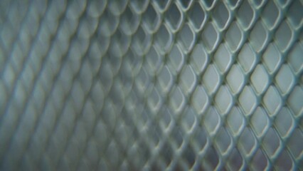 A hyper macro shot of a metal grid, steel pattern, iron industrial texture, aluminum material, super slow motion, Full HD 120 fps, pan right smooth movement