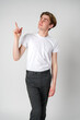 © fotofabrika - Young Man in White T-Shirt Gesturing Upwards Against a Neutral Backdrop