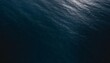 aerial view of surface of deep dark blue sea with reflection of the sun s rays as background for page template or web banner