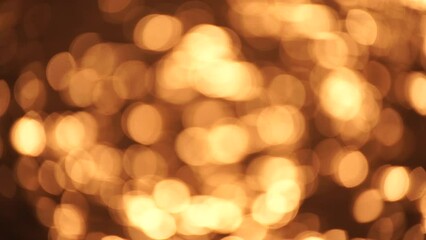 Wall Mural - Abstract Blurred video screensaver bokeh golden sea at sunset. The sun reflects and sparkles on the waves.