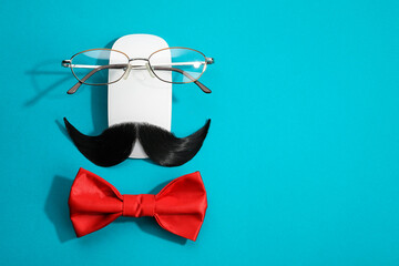 Poster - Flat lay composition with artificial moustache and glasses on light blue background, space for text