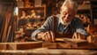 © JovialFox - man owner a small furniture business is preparing wood for production. carpenter male is adjust wood to the desired size. architect, designer, Built-in, professional wood, craftsman, workshop.