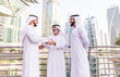 © oneinchpunch - Three business men walking in Dubai wearing traditional emirati clothes