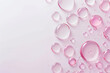 Drops of soft pink cosmetic oil on a white background. Pink background for design.