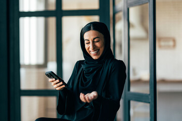 Traditional arabian family from Dubai spending time together at home