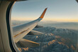 Landscape view with the flight wing from an airplane through window seat