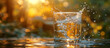 A glass of pure spring water on green nature background and sun light.