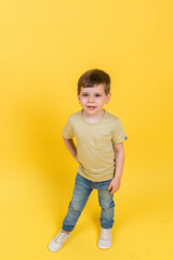 Smiling boy on yellow background
