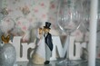 Closeup shot of a figurine of a wedding couple near a Mr and Mrs sign