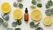 lemon essential oil on a white background with eucalyptus leaves and half an orange