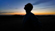 © astrosystem - Man looking at night skies, observing celestial objects, Moon, planets, meteors.