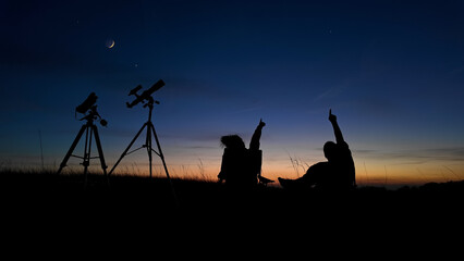 Wall Mural - people enjoying watching and stargazing with astronomy telescopes outdoors in nature, observing plan