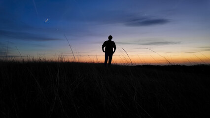 Wall Mural - man looking at night skies, observing celestial objects, moon, planets, meteors.