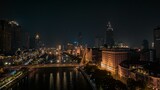 Fototapeta  - Aerial shot of glowing cityscape with the city traffic at night