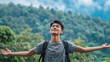 © Keitma - Portrait of a free happy Asian man with open arms enjoying life in meadows and nature background , young joyful chinese male with good mental health