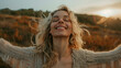Portrait of a free happy blond hair caucasian woman with open arms enjoying life in meadows and nature background , young joyful female with good mental health