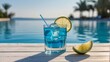 © Nastya - summer blue cocktail with lime on wooden table near the swimming pool