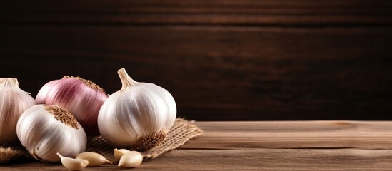Aufkleber - Garlic bulbs and cloves on wooden surface